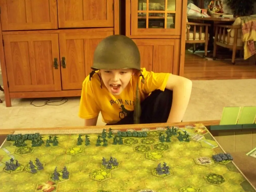 My little GI plots his attack in Dad's old helmet