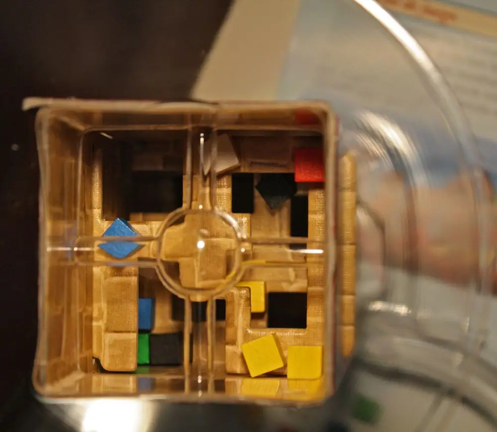 Cubes in the dice tower. Notice that the green cube has very small chances to get out of its current position (safely protected in the corner).