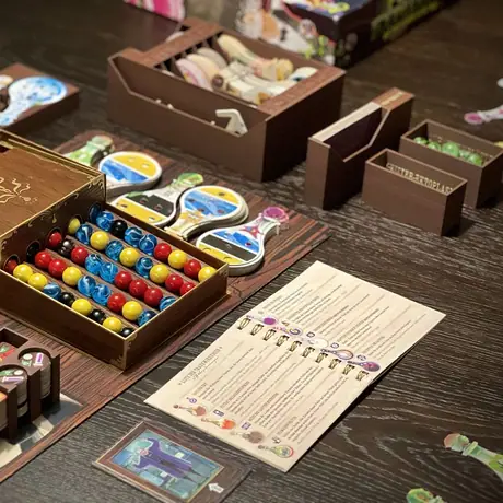 Upgraded Premium Edition with a painted dispenser, custom marbles, a playmat, a custom 3D insert made with wood filament and a complete and compact 4-player rulebook for the base game, all expansions, and promos.