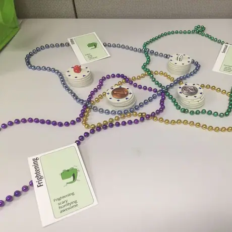 Got some cheap beads at work and my cogs started turning. Using some poker chips, Apples to Apples cards, a few random tokens (I should just mark the chips but I didn't have a marker), and playing cards #1-4 (not pictured), I fashioned a copy of Knit Wit!