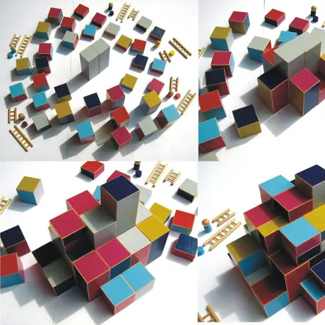 Building phase before the actual game: Starting with the two large grey blocks in the middle, all players create a huge wooden block-tower hiding the central ones