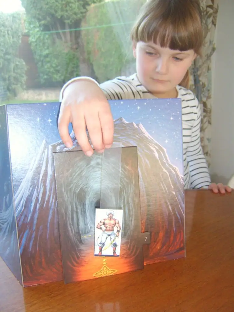 Charlotte demonstrates my prototype for a drop-down 'King of Thieves' prop - adds a smidgen more theatre for family games of SidiBaba.