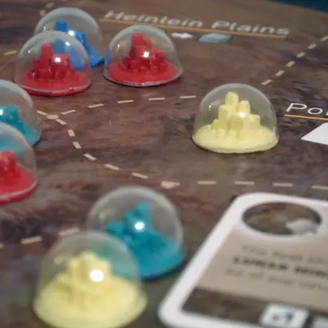 Mid-game with custom pieces that my brother and I made.  Together we molded and cast the city from Fortress America and vacuum formed little domes for each. It was quite a bit of work but worth it!