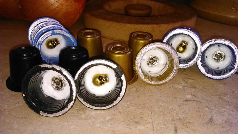 HandMade with recycled coffee pods, tibetan trinkets and silicone sealant.